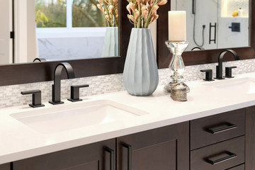 Luxury modern home bathroom interior with dark brown cabinets, white marble, walk in shower, free...