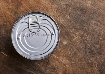 tin can on wooden background isolated