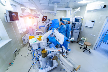 Clinic interior with operating surgery table, lamps and ultra modern devices, technology, hi-tech...