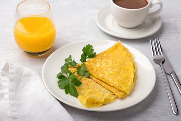 Keto breakfast high-fat low-carb, pancakes without flour and nuts, ketocoffee (bulletproof) with coconut oil, freshly squeezed orange juice on a light gray background
