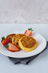 Cheesecakes with berries on a white background