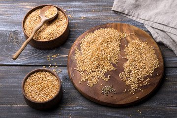 Golden flax seeds on wooden table. trash removal process. healthy vegan superfood