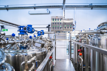 Production of yogurt and milk at dairy factory, industrial equipment for fermentation.