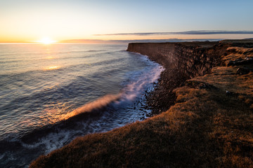 Obraz premium Beautiful sunset at scenic Krisuvikurberg cliffs on a warm bright day in autumn at the rough atlantic coast in iceland