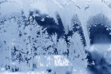 Fototapeta na wymiar Beautiful ice pattern on winter window glass
