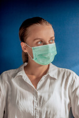 girl in a medical mask on a dark blue background