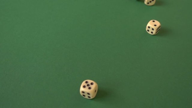 throwing dice on a green surface