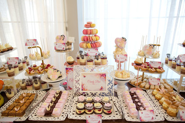 Delicious candy bar with macarons, cucakes and other sweets