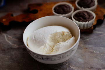 Chocolate cupcakes. Homemade chocolate muffins. The process of making homemade chocolate cupcakes with whipped cream and decorated with chocolate and raspberry pieces.