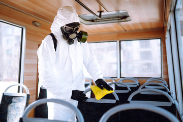 Hand of Man in protective suit washing and disinfection public transport, to preventing the spread of the epidemic of coronavirus, pandemic in quarantine city. Covid-19.