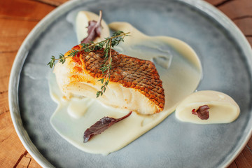 portion of white fish steak with bechamel sauce