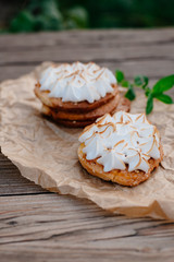Meringue cakes. Cakes with protein cream on a wooden background.