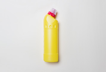 yellow bottle with detegrent on colored paper background