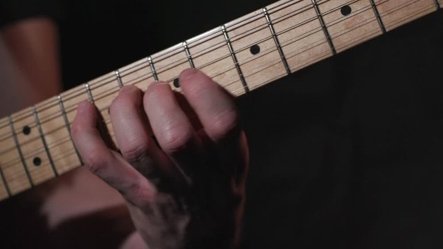 Male guitar player practices B Flat Scale on Electric Guitar