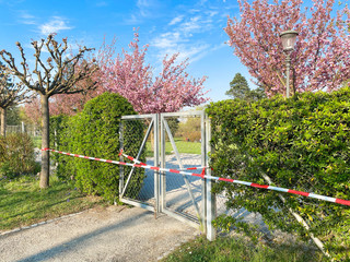 Entry goal to the park is closed and wrapped in alarm caution tape for global coronavirus quarantine. No people outdoor in Europe. Prevention of coronavirus COVID-19.