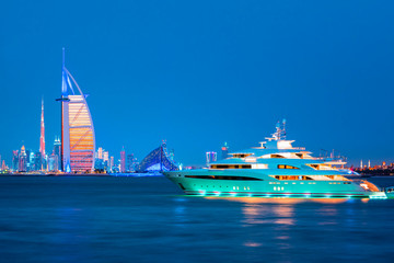 Fototapeta premium Dubai Marina, city of tourism from Palm Island at sunrise, United Arab Emirates