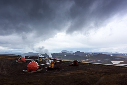 Geothermal Energy Power Plant In Iceland Mountains. Industrial Landscape