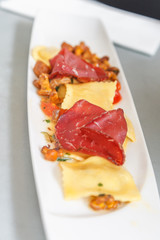 Starter, stuffed ravioli with mushrooms and ham.   