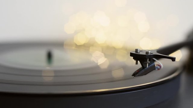 Turntable playing vinyl LP record at home. Party, leisure, music, hobby, enjoying life, having fun, technology concept.