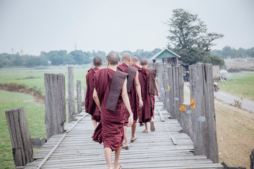 monks walking in ubein bridge