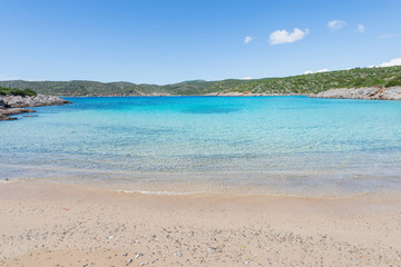 Beautiful sandy beach and crystal clear water at Agia Dynami beach on Chios island, Greece.