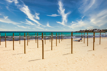 On Sa Coma on the Mediterranean island of Mallorca there are wooden poles in the beach on which the parasols are placed at the start of the season