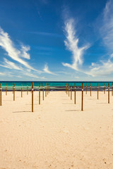 On Sa Coma on the Mediterranean island of Mallorca there are wooden poles in the beach on which the parasols are placed at the start of the season