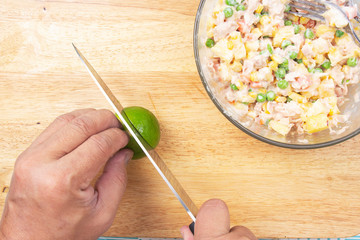 Chef cutting lime for cooking corn salad