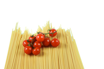 spaghetti and cherry tomatoes: typical ingredients of Italian cuisine in a minimalist composition with a totally white background