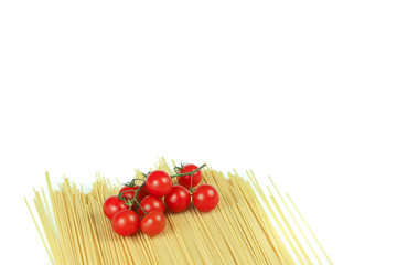 
full frame of spaghetti and cherry tomatoes on a wooden table with white background