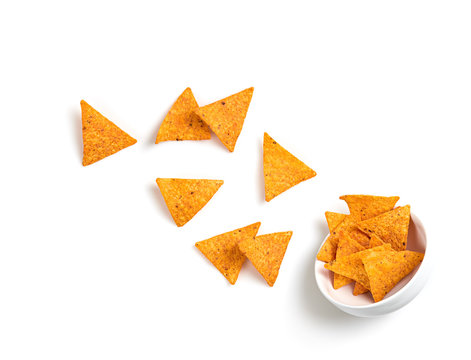 Nachos Mexican Corn Chips Flying. Vegan Nachos Snack Falling Into Bowl Isolated On White Background. Tortilla Nacho Crisps, Levitation Fly Creative Concept