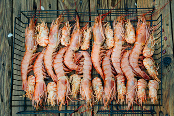 Grilled prawns. The process of cooking shrimp in soy sauce on the grill. Thai food.