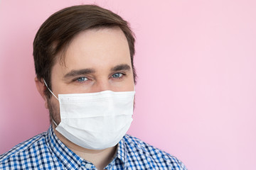 Coronavirus, illness, infection, quarantine, medical mask. Man wearing protective mask on pink background, copyspace, copyplace, space for text.