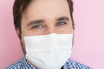 Man in a surgical bandage on pink background. Copyspace, copyplace, space for text. Coronavirus, illness, infection, quarantine, medical mask