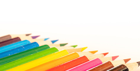 assorted colored pencils used for drawing and coloring on a white background