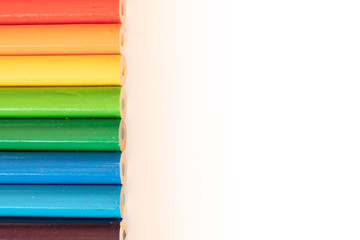 assorted colored pencils used for drawing and coloring on a white background