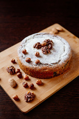 Biscuit with poppy seeds and nuts dusted with icing sugar. Homemade sponge cake with poppy seeds and nuts.