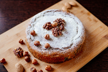 Biscuit with poppy seeds and nuts dusted with icing sugar. Homemade sponge cake with poppy seeds and nuts.