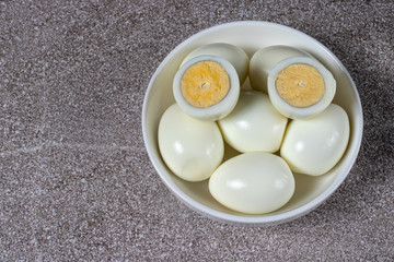 Boiled peeled eggs without shell on a plate. Ingredients for cooking.