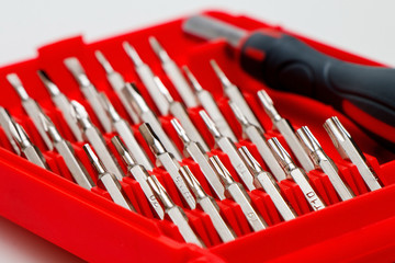 Fototapeta premium Tool kit for home and repair. Screwdriver with nozzles of different types in a red box.