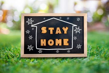 Biscuits. The word Stay Home in chalk stripes. A white picture of a house. And there was a drawing of a corona virus in the blackboard on the grass.