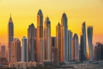 Fototapeta na wymiar Amazing and Luxury Dubai Marina skyscrapers, famous Jumeirah beach skyscrapers at sunrise, United Arab Emirates