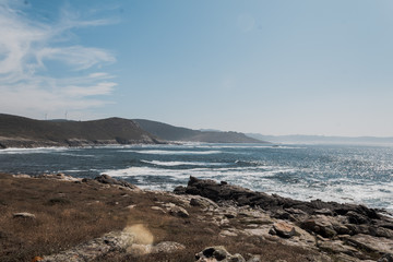 Open sea coast with a cape in the background