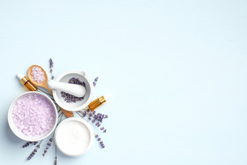 Set of natural organic lavender cosmetics on blue background with copy space. Homemade SPA beauty products for skin treatment. Flat lay, top view