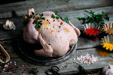 Raw chicken on the table with spices. Village style. © Юрий Ваховский