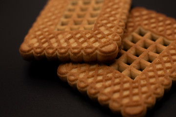 Two cookies on a dark background