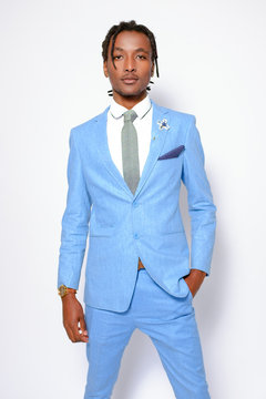 Good-looking African business man man wearing blue suit white shirt and grey tie stand