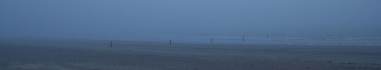 A view over the beach with fog