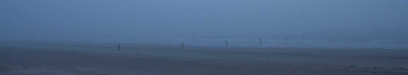 A view over the beach with fog
