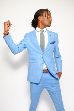 Good-looking African business man wearing blue suit white shirt and grey tie stand